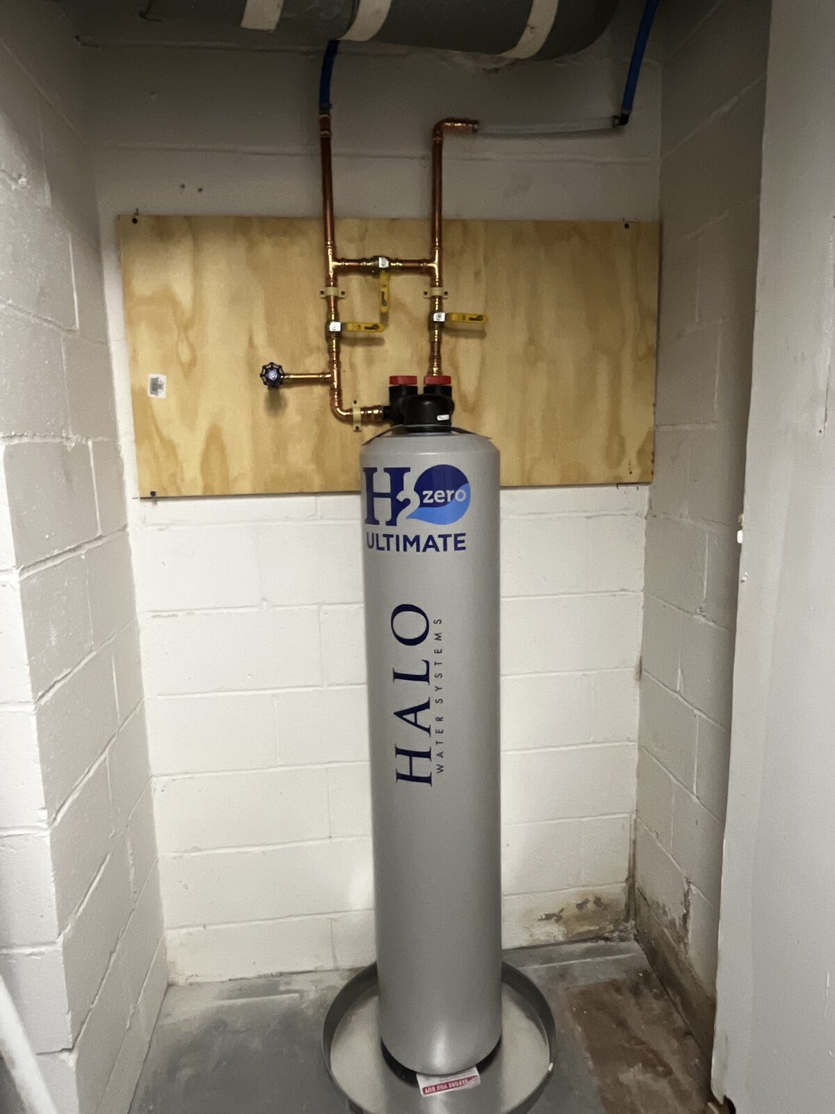 HALO H2zero Ultimate water conditioner installed in a basement with new copper manifold and bypass valves